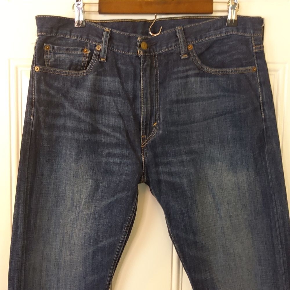 Levi 513 slim straight Blue dark wash mildly distressed five pocket jeans